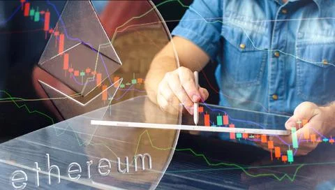 ETH  trading chart on the screen. Holding in hand a gold Bitcoin Cash coin. T Stock Photos