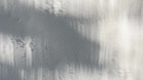 Ethereal abstract shadows dance across textured white plaster wall creating atmo 스톡 동영상 333569048