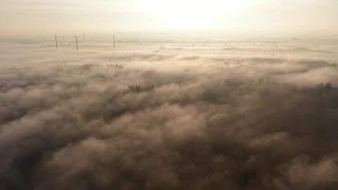 An ethereal aerial drone view looking over a thick blanket of morning mist Stock Footage 336406829