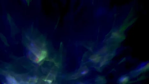 Ethereal aurora borealis style light projection dances across dark textured wall 스톡 동영상 333569066
