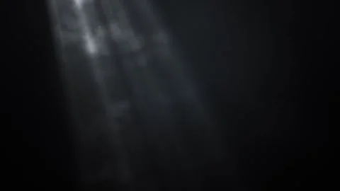 Ethereal beams of light piercing through dark shadows Video stock 295324106