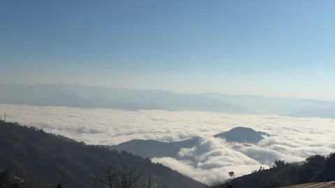 Ethereal Clouds and Mist Covering Green Mountain Slopes Stock Footage 332382555