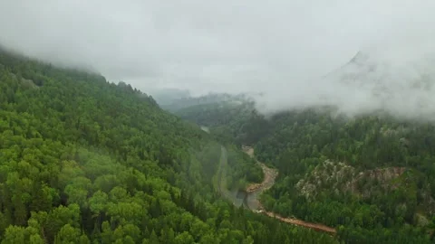 Ethereal clouds gliding over a serene mountain valley Видео 287221463