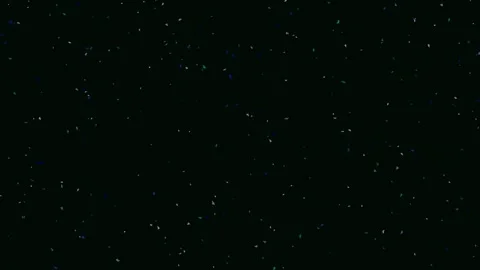 Ethereal cosmic dust particles drifting through a deep black void background Stock Footage 342114960
