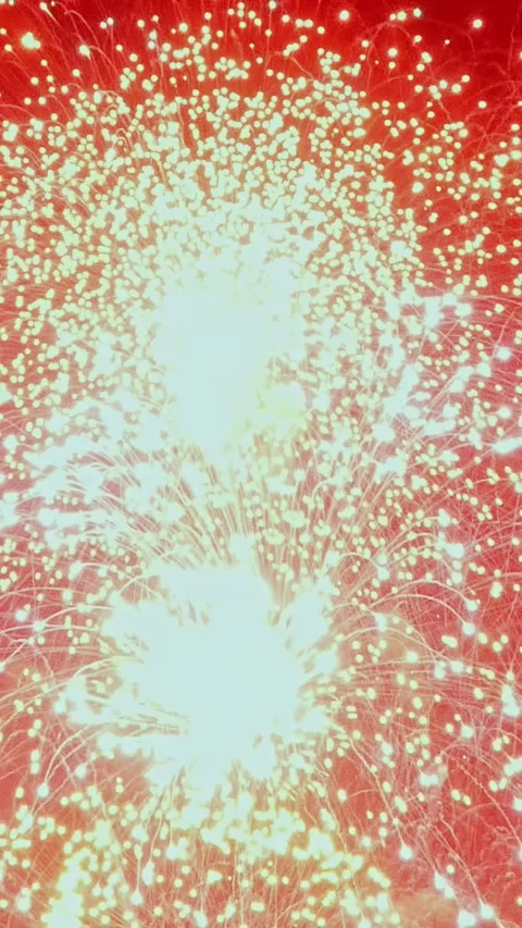 Ethereal Dance of Light From Holiday Fireworks at Nightfall Stock Footage 323376433