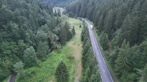 Ethereal Drone Flight Through Misty Mountain Passes with a Winding Valley Road Stock Footage 314237070