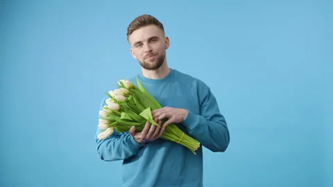Ethereal elegance: man embracing white tulips Stock Footage 273803744
