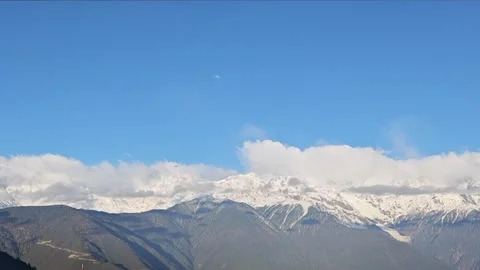 Ethereal Sea of Clouds Flowing Around Meili Snow Mountain Stock Footage 332182279