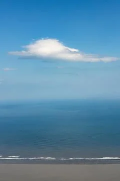 Ethereal white cloud hovering over the blue ocean at the coast of Iceland Stock Photos