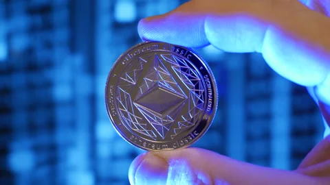 Ethereum classic coin held in hand between fingers Stock Footage 160985800