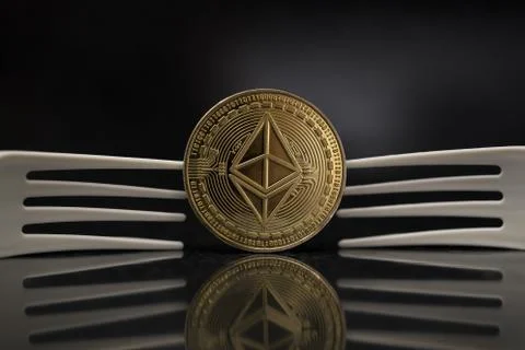 Ethereum Classic placed between Two Plastic Forks Stock Photos