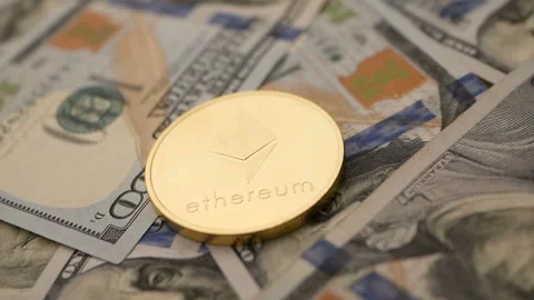 Ethereum ETH coin rotating on bills of 100 dollars Stock Footage 87479070
