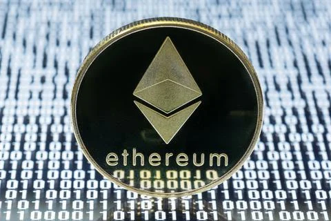 Ethereum physical coin on binary code Stock Photos