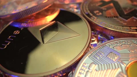 Etherium ETH gold and silver coins rotate on the table with another cryptocoins Stock-Footage 129608656