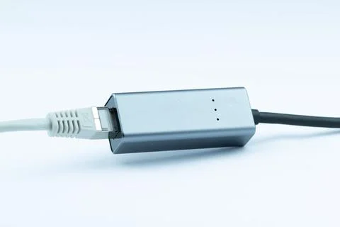 Ethernet adapter connected to a cable, ready for network connection.  Compa.. Stock Photos