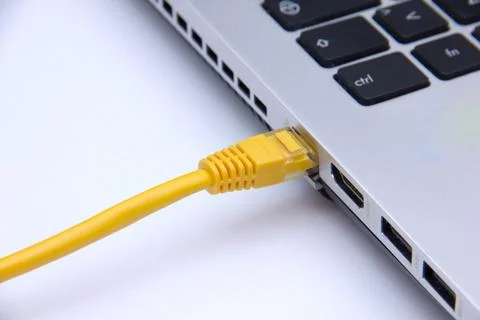 Ethernet cable connected to the computer seen up close Stock Photos