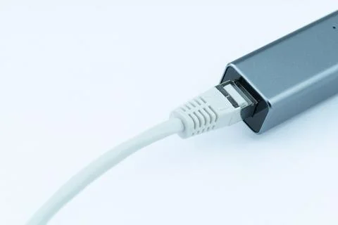 Ethernet cable plugged into a gray network adapter.  High-speed internet co.. Stock Photos