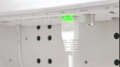Ethernet Cable Plugged into High Speed 10G Port on White Internet Router 库存影片 348696676