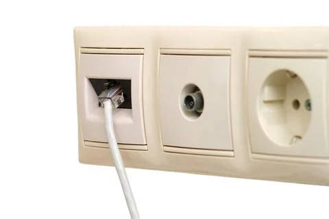 Ethernet cable plugged into wall outlet. Network connection interface with in Stock Photos