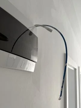 Ethernet cable protruding from wall for internet installation in modern hom.. Photos