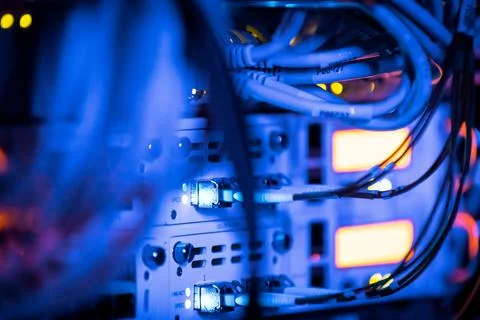 Ethernet cable stuck in a server with maintenance monitor in blue light glow Stock Photos