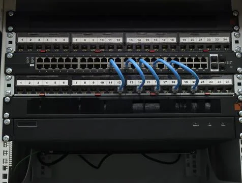 An Ethernet switch and patch panels. Stock Photos
