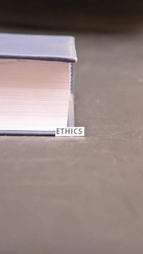 Ethics Concept on Paper Bookmark Between Books Close Up Vertical Video Stock Footage 338238309