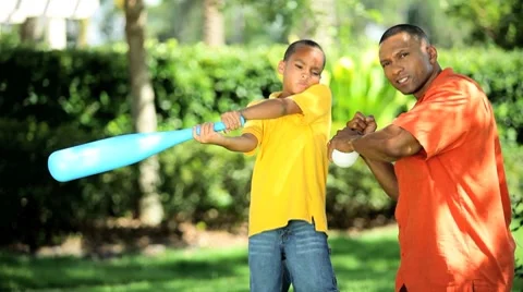 Ethnic Father &amp; Son Practicing Baseball Swing Stock Footage 7769846
