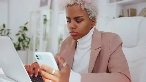 Ethnic female using mobile application to sync data with computer via bluetooth. Stock Footage 164635617