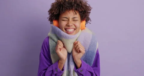 Ethnic girl eager to hear something very pleasant clenches fists and closes eyes Stock Footage 144453473