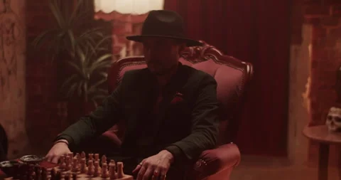 Ethnic man in hat inviting for playing chess Stock Footage 260559117