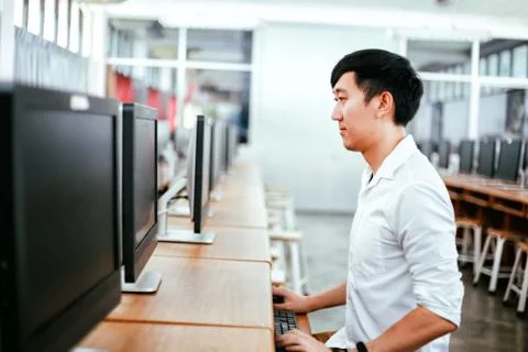 Ethnic man using computer in classroom 스톡 사진
