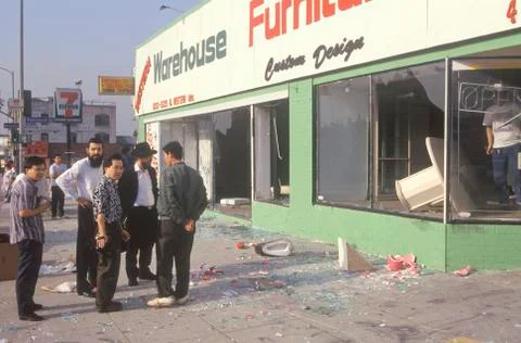 Ethnic men observing furniture store looted during 1992 riots, South Central Los Stock Photos