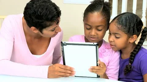 Ethnic Mother and Daughters Using Wireless Tablet Stock Footage 8989786