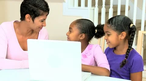 Ethnic Mother Watching Daughters Using Laptop Stock Footage 8989700
