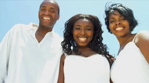 Ethnic parents and daughter using internet video communication on beach vacation Stock Footage