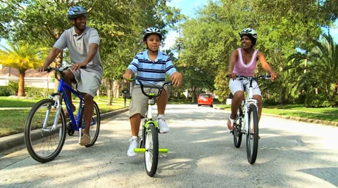 Ethnic parents boy family bicycle cycling outdoor healthy lifestyle together Stock Footage