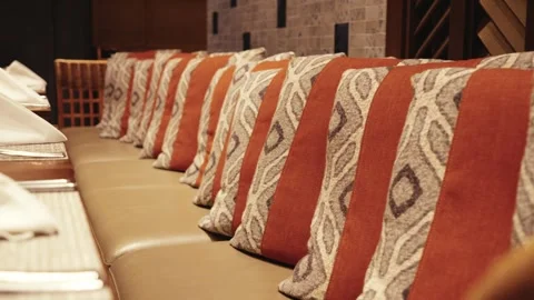 Ethnic Patterned Cushions on Leather Dining Bench Stock Footage 333814702