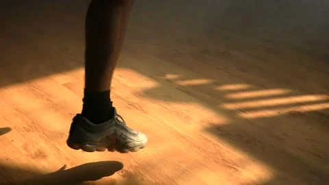 Ethnic young man dancing feet under light ray. Stock Footage 153030053