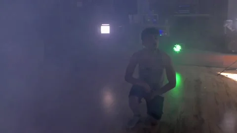 Ethnic young man dancing solo routine with smoke. Stock Footage 153030267
