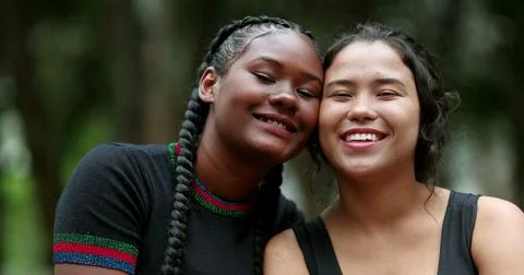 Ethnically diverse girlfriends posing together. African and hispanic girls Stock Photos