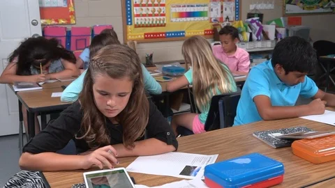 Ethnically diverse students working in classroom Stock Footage 99375397
