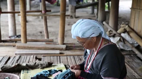 Ethnically dressed lady working on her handicrafts in Chiang Mai Stock Footage 130555329