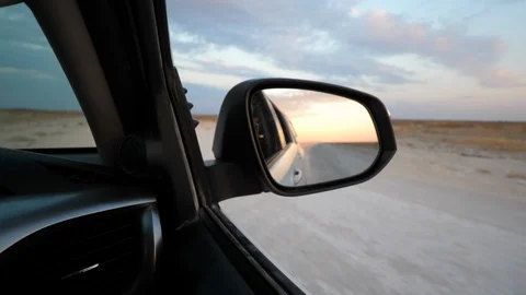 Etosha sunset, rearview mirror, Namibia, Africa in 4K, running car Stock Footage 90829274