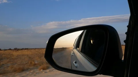 Etosha sunset, rearview mirror, Namibia, Africa in HD, running car Stock Footage 90862739