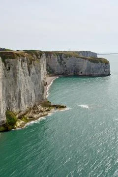 Etretat Chalk Cliffs and Pebble Cove Above Turquoise Sea Stock Photos