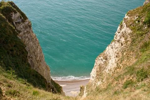 Etretat Chalk Cliffs Framing Turquoise Sea and Pebble Beach Stock Photos