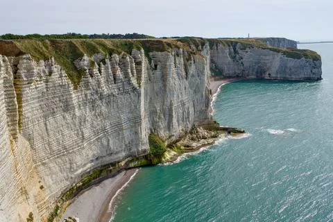 Etretat Layered Chalk Cliffs and Curving Pebble Beach Stock Photos