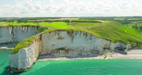 Etretats iconic chalk cliffs on a beautiful sunny day, slow camera pan, 4k Stock Footage 247647416