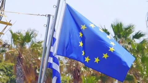 The EU and Greek flags flutter side by side in a Mediterranean breeze in sl.. Stock Footage 290087294